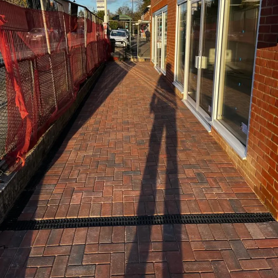 After: block paved walkway with a channel drain