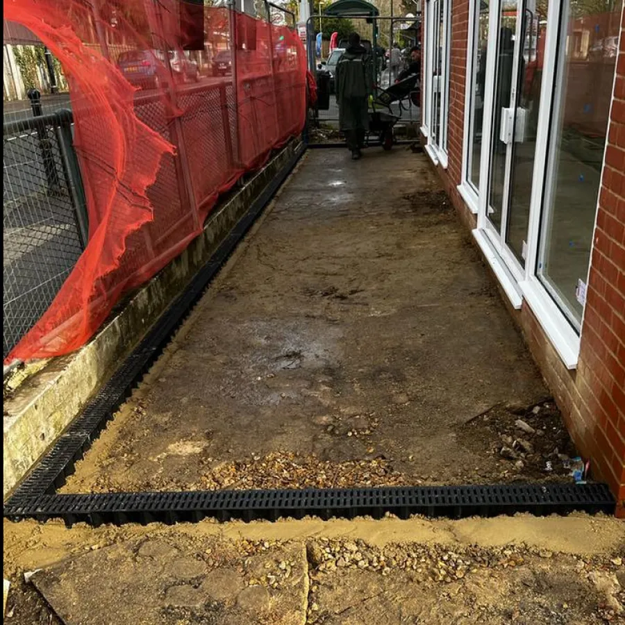 Before: block paved walkway with a channel drain